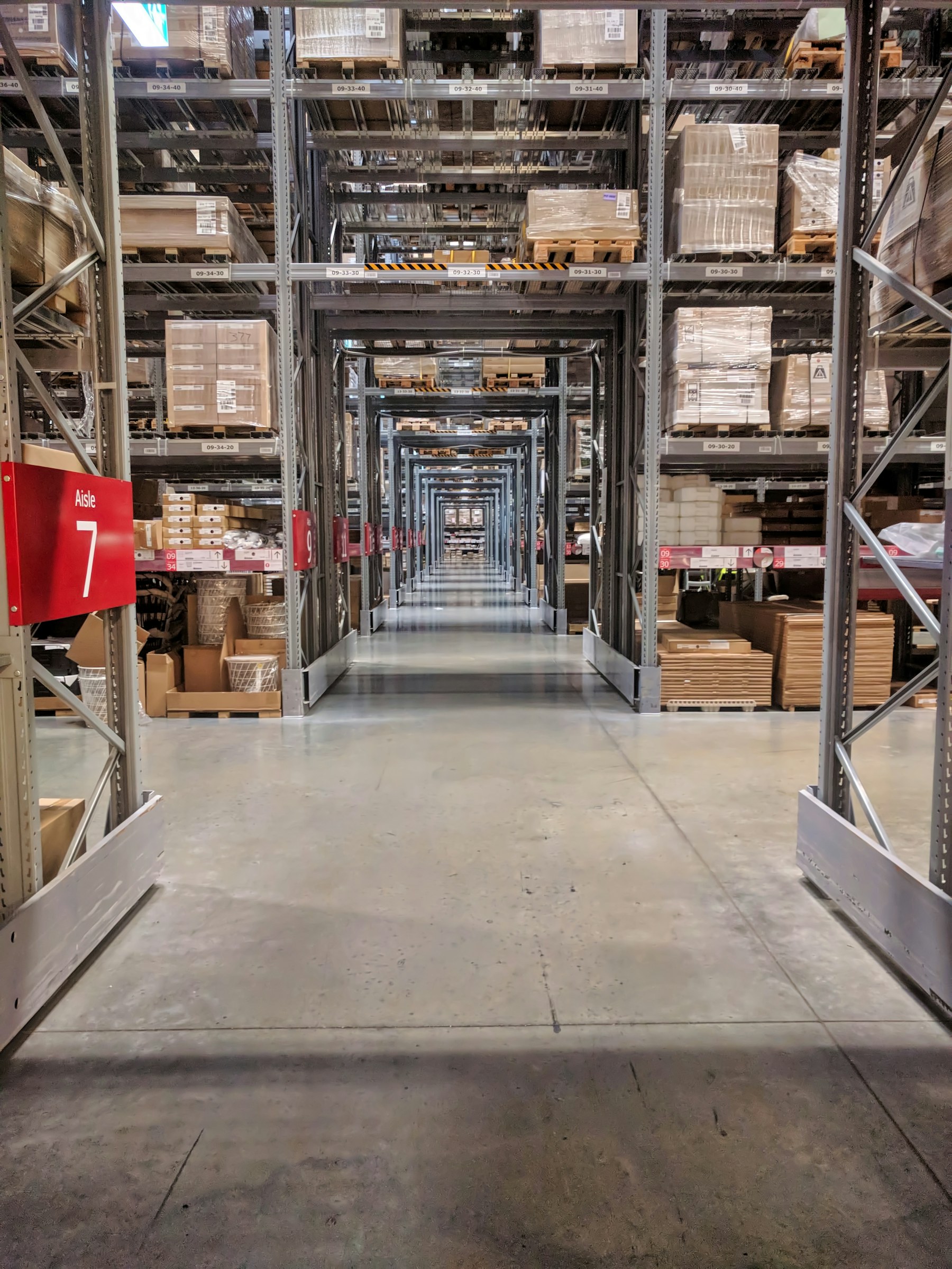 Organized warehouse aisles with neatly stacked goods and storage shelves